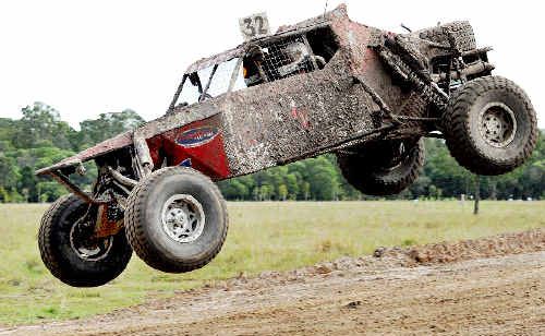 Townsville’s Michael Marson, in his number 32 pro buggy, takes to the air on the crowd-pleasing jump. Townsville’s Michael Marson, in his number 32 pro buggy, takes to the air on the crowd-pleasing jump.